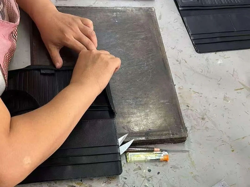 Inspeksi kualitas apa sing ditindakake Godere sadurunge kiriman dompet?